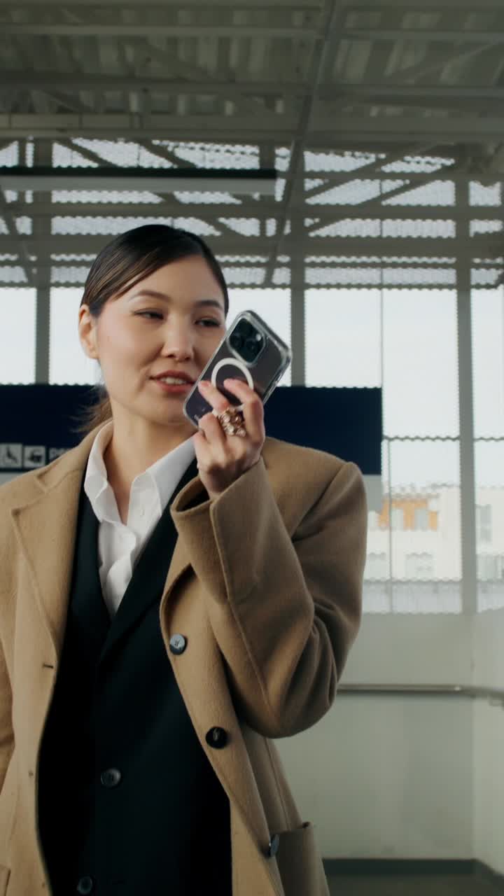 mujer usando el teléfono en la estación de tren