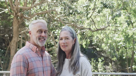 Middle-aged-portrait-of-caucasian-couple-in-garden-with-copy-space