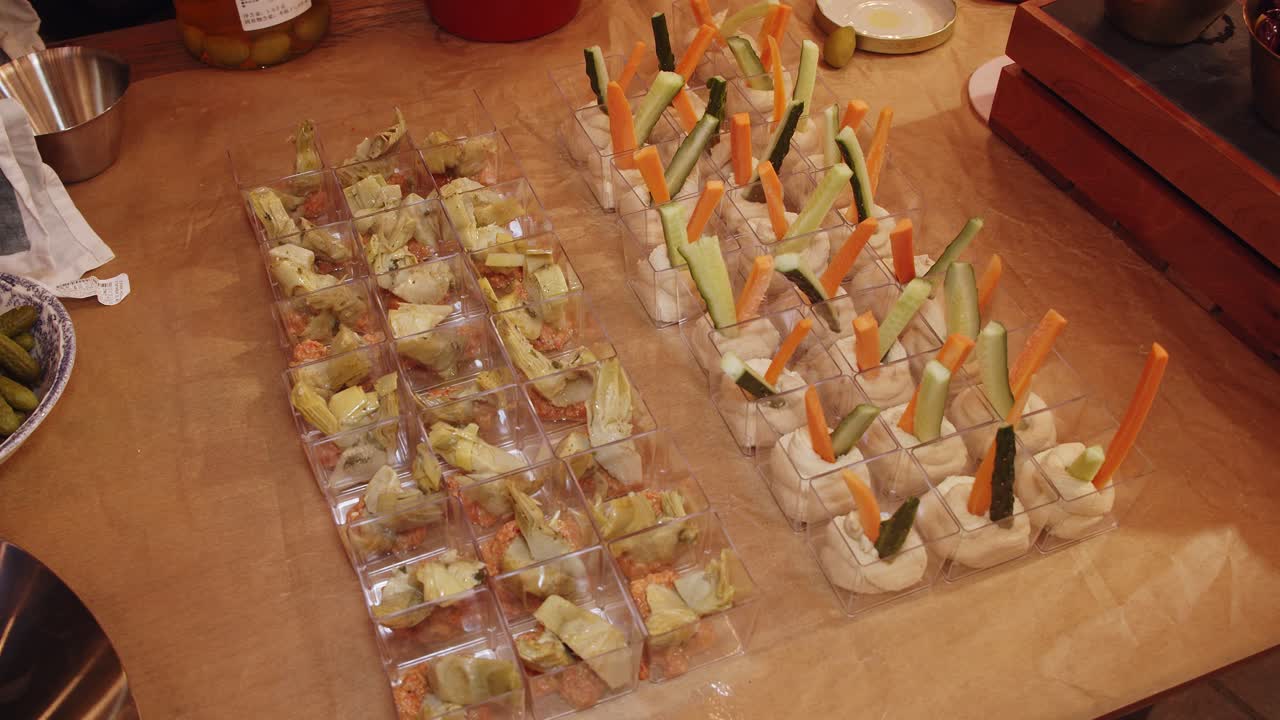 저녁에 야외 케이터링 테이블에 놓인 허머스, 당근, 오이 푸드 스타터