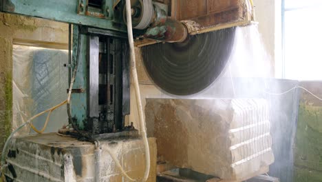 automatic machine with water supply is cutting cobble on the manufacturing. stone processing