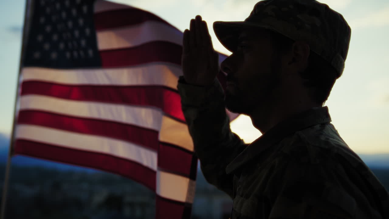 Silhouette Of A Soldier Salutes In Front American Flag At Sunset Memorial Day