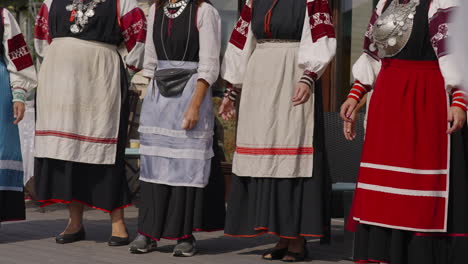 Traditional-Estonian-Dance-Performance,-Women-Moving-Dressed-in-Colorful-Folk-Dresses-Costumes-and-National-Embroidery-Outfits-and-Ornament