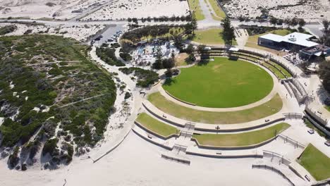 static aerial shot over shorehaven beach alkimos and shipwreck park with green circular grass area