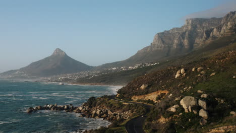 drone shot from camps bay of lions head and twelve apostles around cape town, south africa