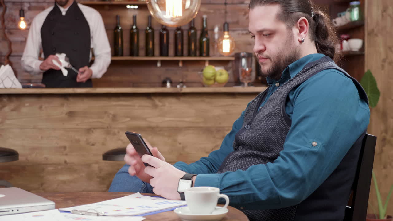 Man using mobile phone in cafe