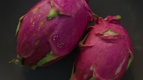 top view of dragon fruit cenital spinning on a plate with a dark background