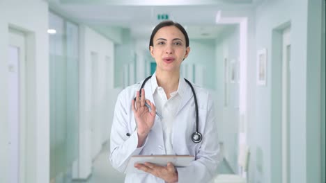 Happy-Indian-female-doctor-talking-to-patient