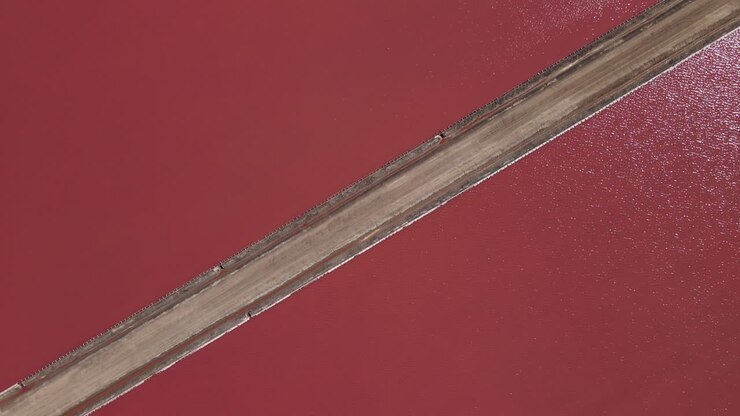 Aerial shot revealing a picturesque, hilly scenery around Lake Grassmere Saltworks