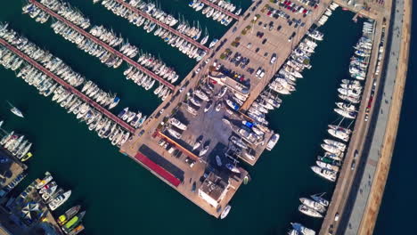 stunning aerial shot flying over boats in harbour in barcelona