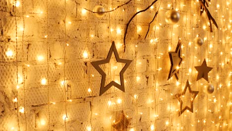 christmas garland with golden lights, close-up. blinking christmas stars lights twinkling. winter holidays concept