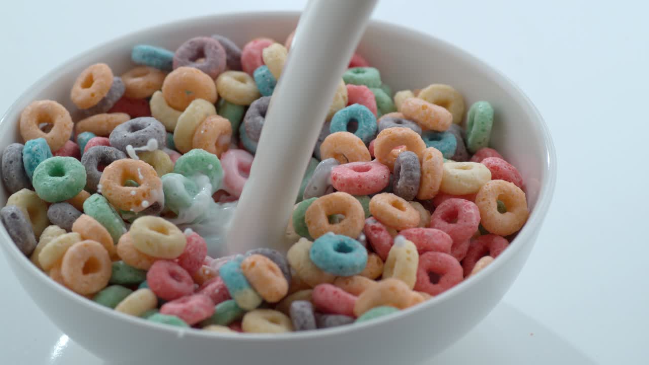Milk pouring into bowl of cereal in slow motion