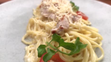 spaghetti with creamy chicken , traditional pasta dish of italian culture made with fresh egg yolk, original grated chesse, juicy chicken and creamy sauce