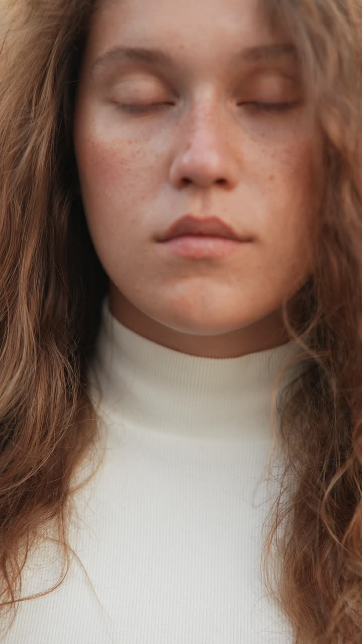 Close-up portrait of a young woman with curly hair