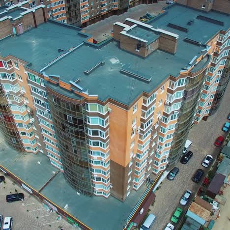new apartment complex in the city. high-raised buildings near the road with moving cars. modern infrastructure in downtown with car parking. comfortable life in the city.