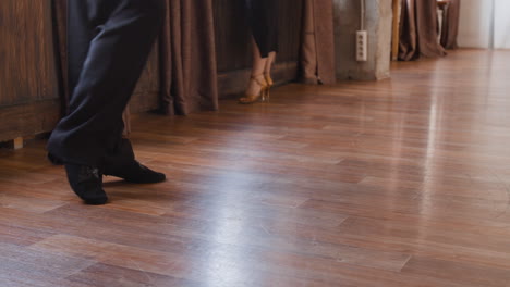 close-up of dancers' feet and shoes on a wooden floor
