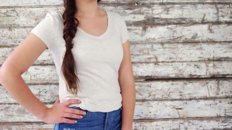 Fashionable-woman-standing-against-wooden-background