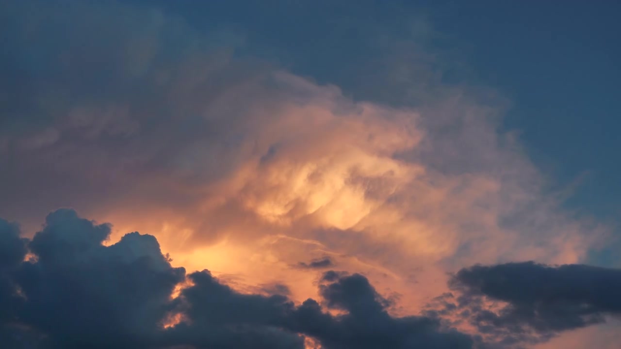 Golden Sunset Clouds Moving Across a Deep Blue Sky