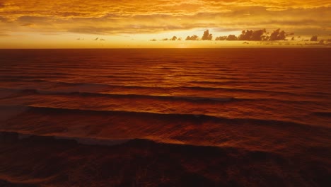 beautiful dramatic golden sunset with cloud filled sky over the tasman sea on the wild, rugged west coast of south island, new zealand aotearoa