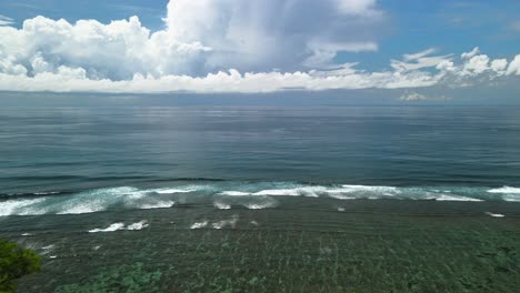 Men-on-the-cliff-in-front-of-beautiful-ocean-in-Bali,-Indonesia