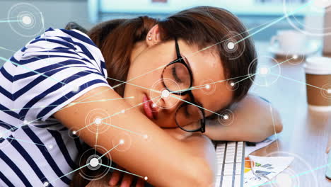 sleeping woman at desk with network connections animation over her