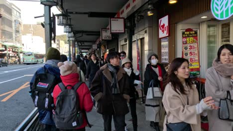 people walking on a busy city sidewalk