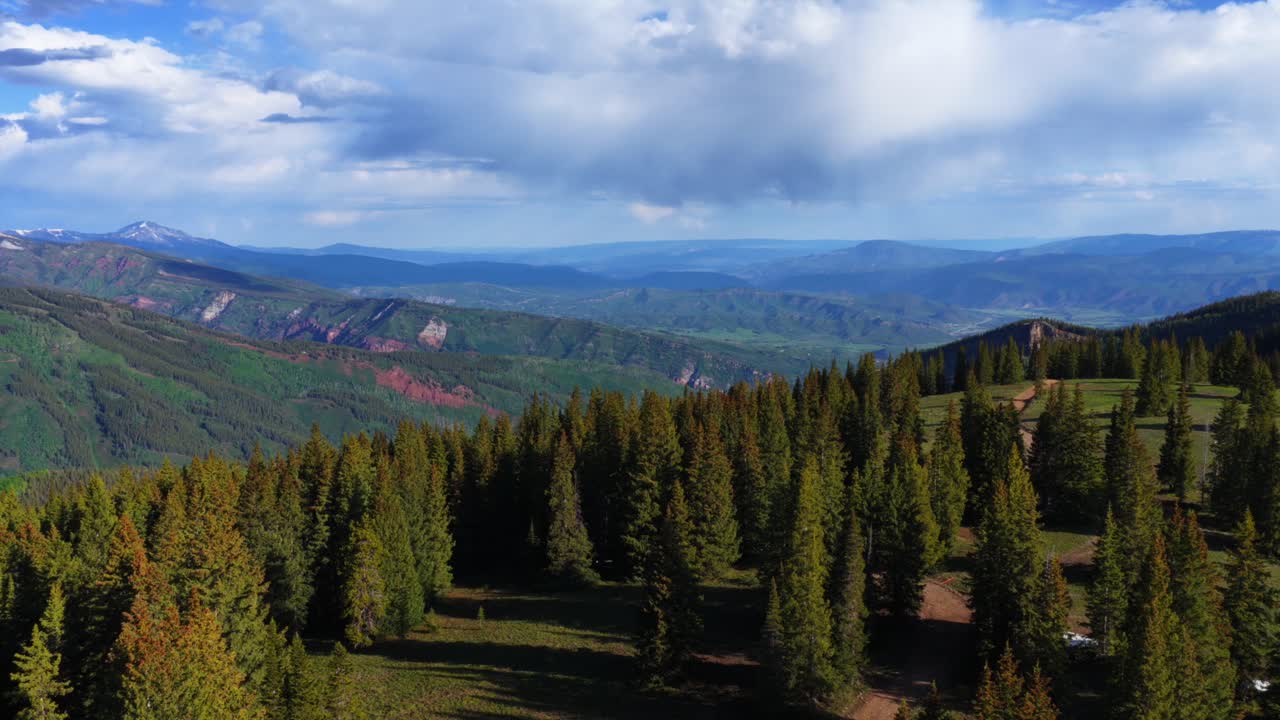 Aspen Highlands Ski Resort Little Annie Basin Trailhead AJAX top of Aspen Mountain aerial drone snow covered Rocky Mountains spring summertime morning sunny blue sky Silver Bell Trailhead circle left