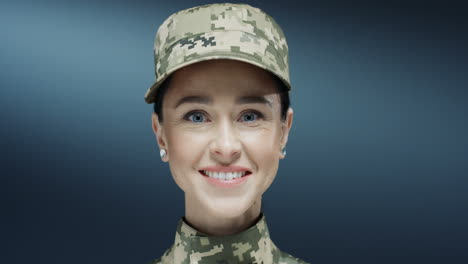 retrato de la joven y atractiva mujer morena del ejército estadounidense con el uniforme y el sombrero sonriendo alegremente