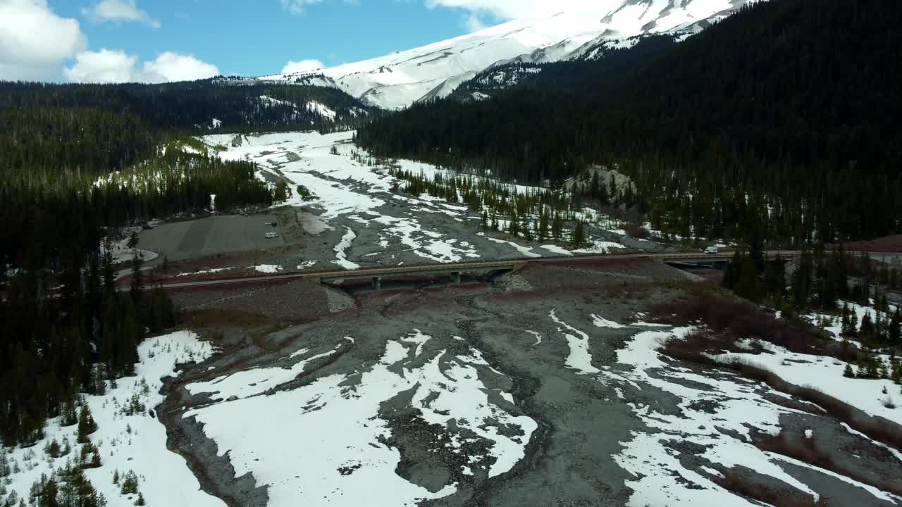 US, Oregon, Mt Hood, White River, 2025-04-22 - Drone view of the frozen river that comes down from Mt Hood. On a beautiful spring day.