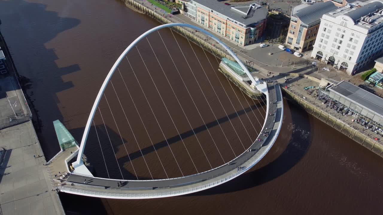Aerial view circling Newcastle's Millennium Bridge on the Quayside