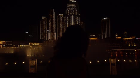 girl in front of a fountain in dubai