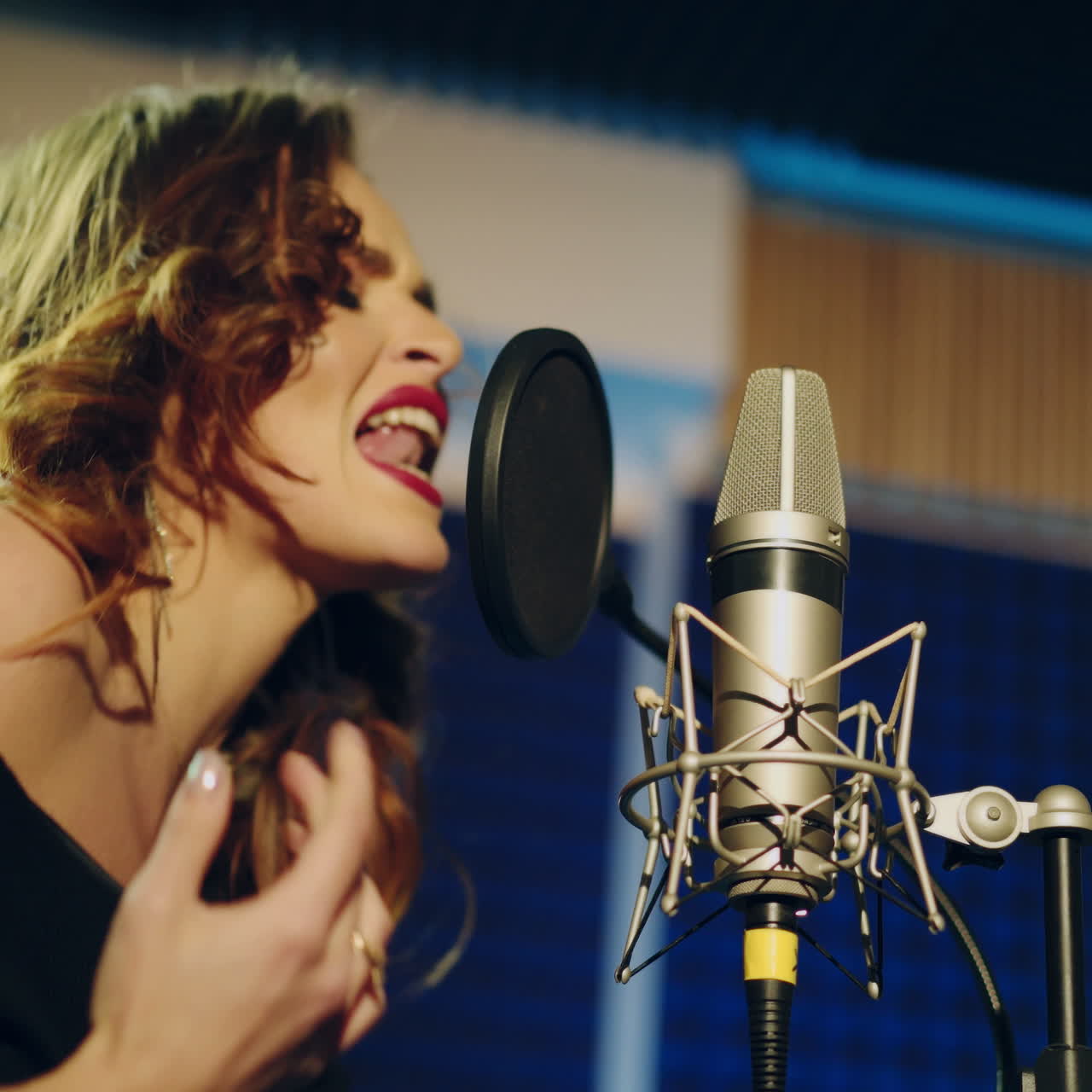 Woman singing in a recording studio. Female vocals. Professional recording studio. Square video