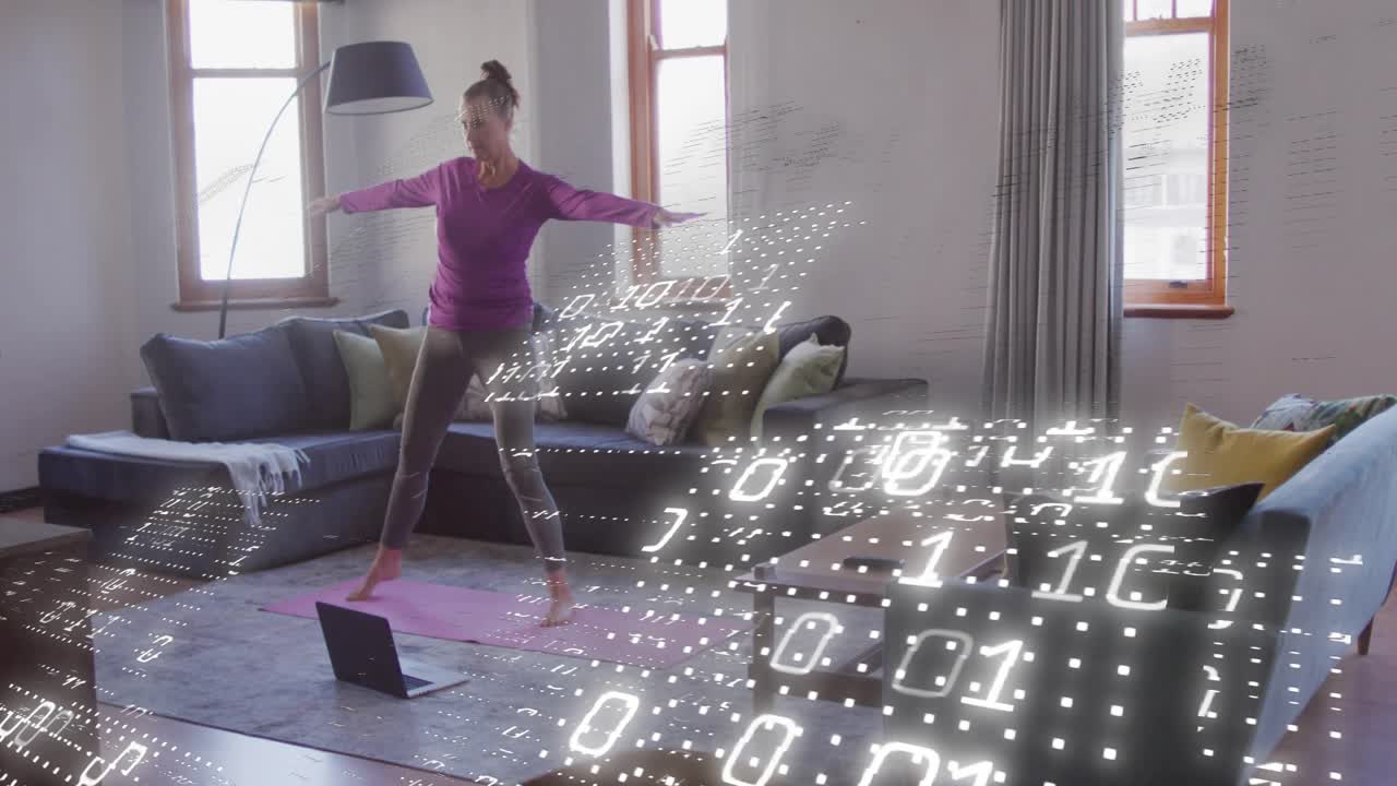 Glancing laptop, woman stepping into warrior II on pink mat with floating binary code for health