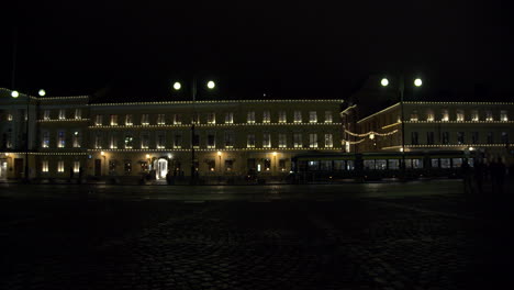 helsinki, finland at night with christmas decoration and the city tram passing by