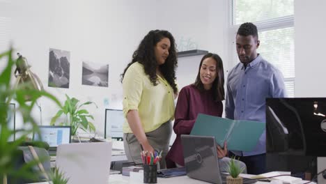 Happy-diverse-group-of-business-people-working-together,-discussing-work-in-modern-office