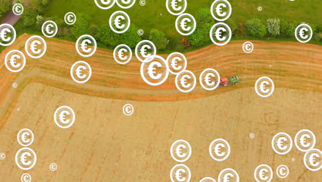 euro currency symbols animation over aerial view of tractor working in field