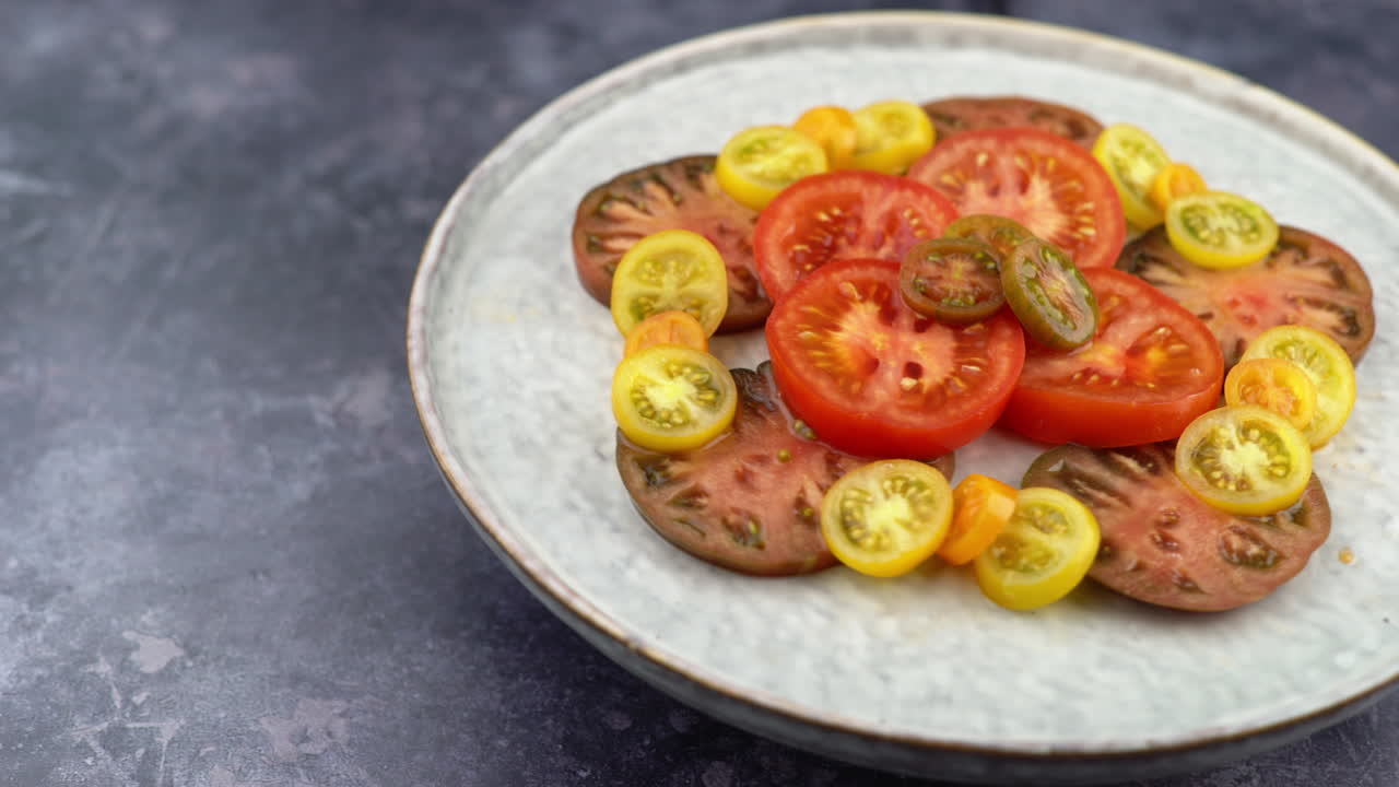 Tomatoes On Plate Rotating With Pan Across. Plate Of Healthy Organic Tomatoes, Healthy Vegetarian Vegan Raw Food. Plant Based Raw Food Meal.