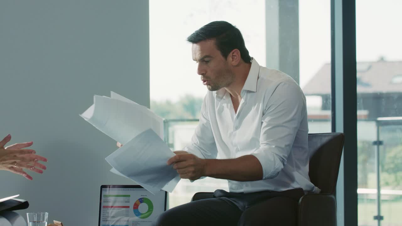 Colleagues discussing working questions. Business man throwing paper.