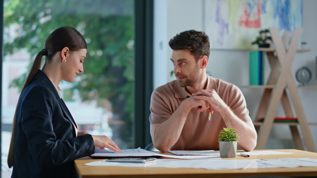 Business consultant calculating project to businessman at office meeting closeup