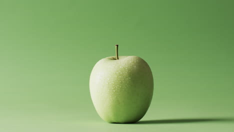video of green apple with copy space over green background
