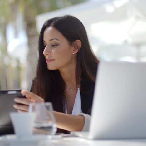 Businesswoman-making-a-call-at-a-restaurant