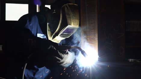 a man welding beams for a walking bridge in slow motion