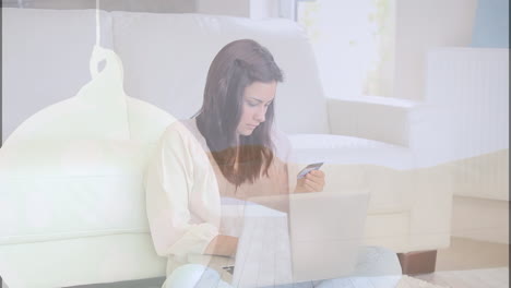 animación de formas sobre mujer caucásica usando computadora portátil