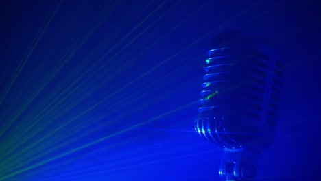 retro microphone with stage disco lights and fog. live performance or karaoke concept.