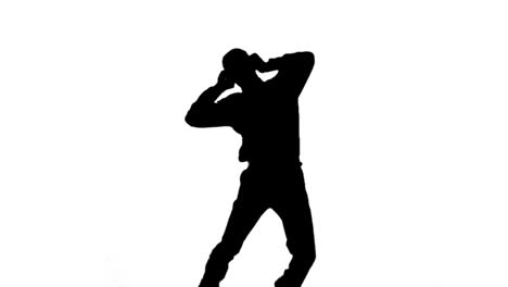 Silhouette-of-a-man-jumping-and-listening-to-music-on-white-background