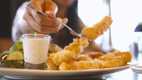 deep fried prawn shrimp, tempura japanese food with happy asian woman in blurred background in restaurant