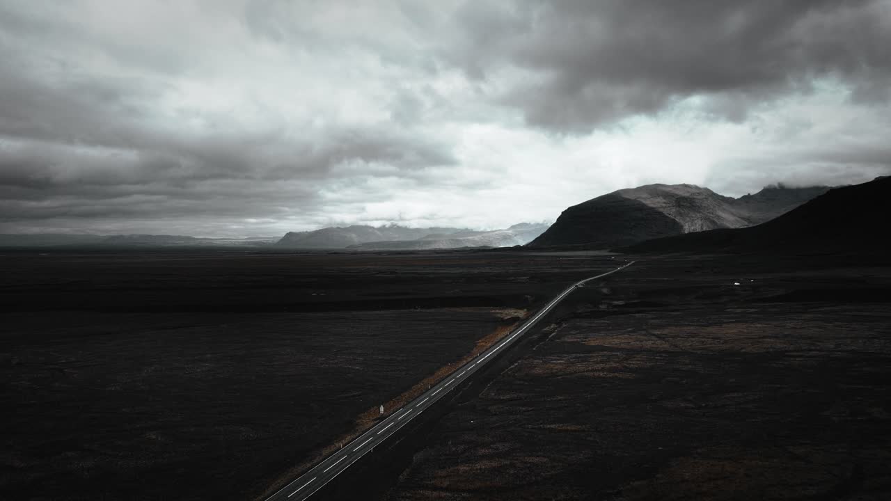 Cinematic aerial ring road in iceland distant volcanic mountain range landscape scenery