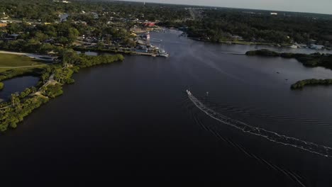 Aerial-view-of-boat-on-calm-waters-at-Millers-Bayou,-Florida