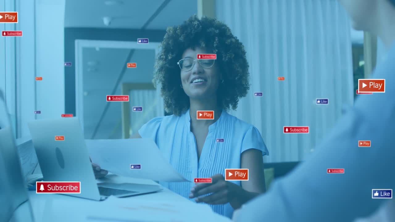 Animation of social media icons with texts over diverse business people having meeting at office