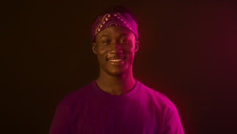 portrait of a smiling man in a purple shirt