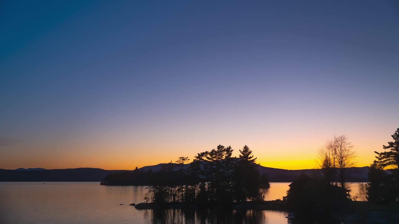 Sunset to dusk time lapse over new England lake golden hour blue hour 4k 30p